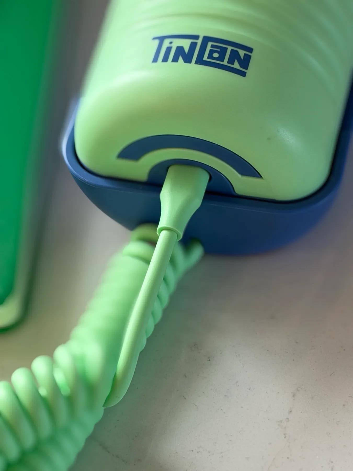 Close-up of the coiled cord where it plugs into the Tin Can handset, the connection that was loose on our first unit