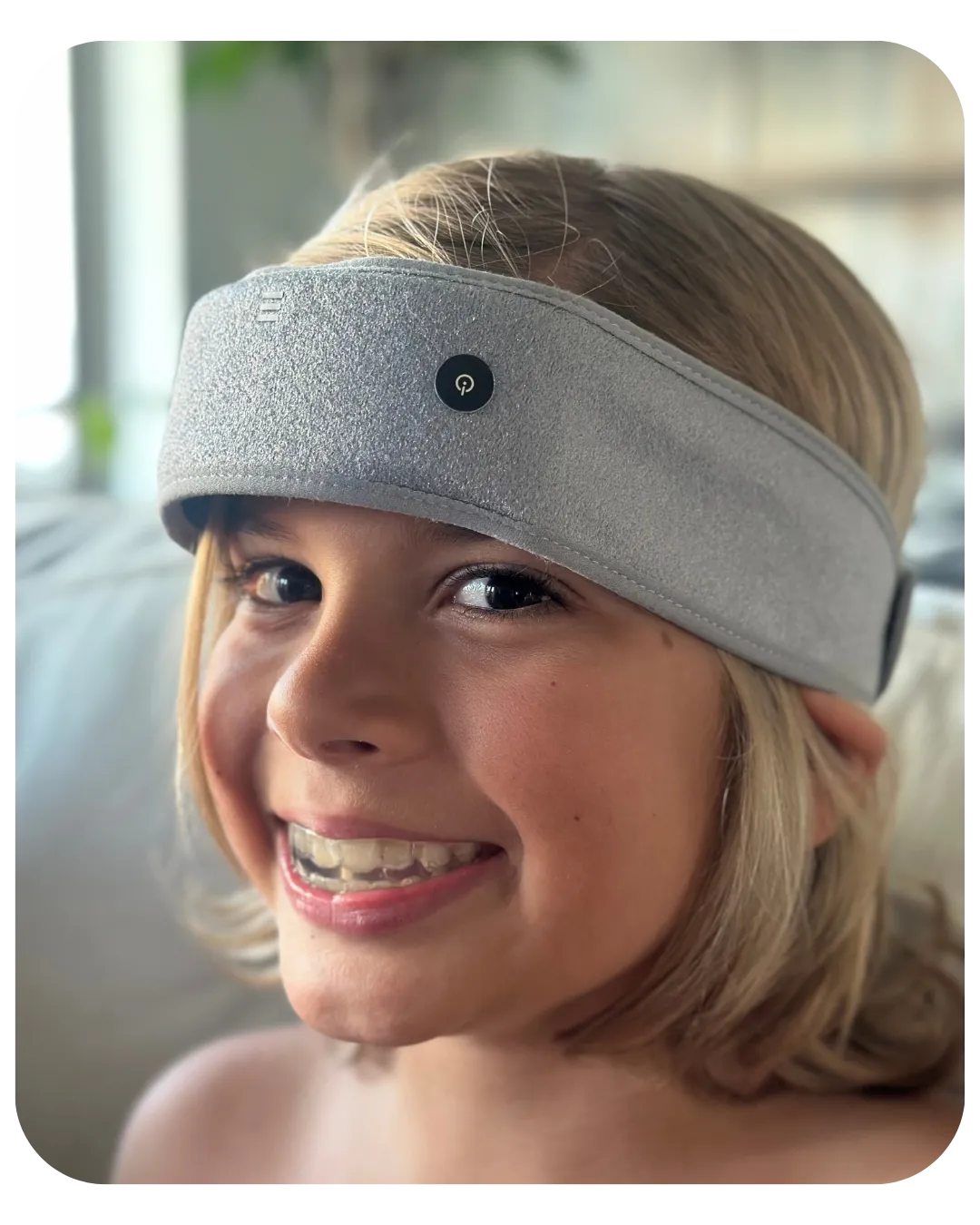 My daughter wearing the SONU Band at home, smiling, indoors with soft daylight
