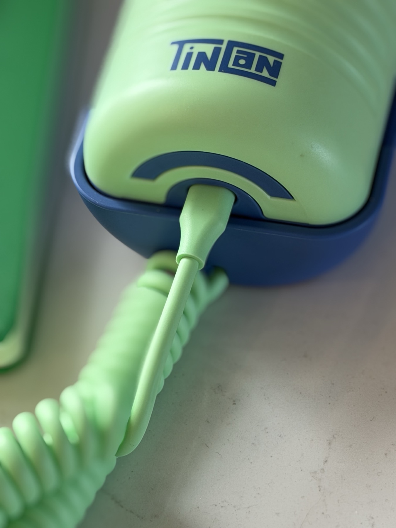 Close-up of the coiled cord where it plugs into the Tin Can handset, the connection that was loose on our first unit