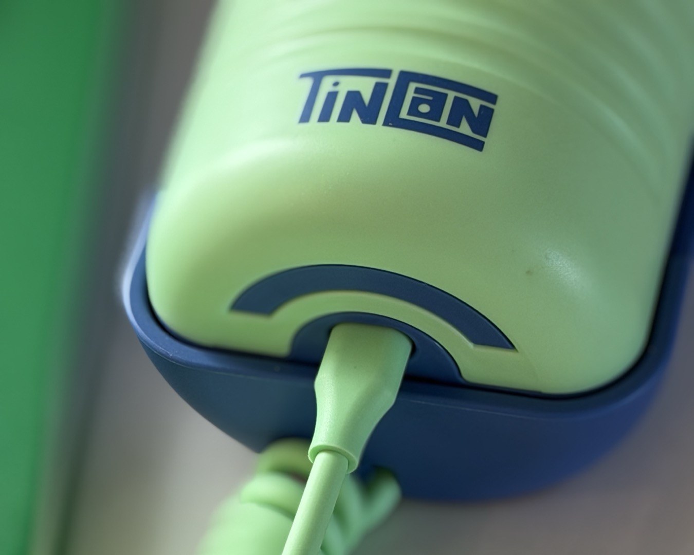 The Tin Can handset seated in its cradle, coiled cord attached